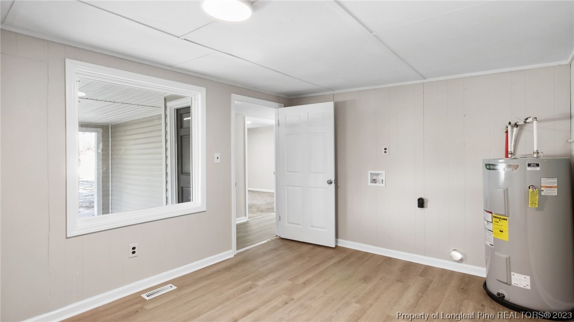 6114 Sandy Creek Road Stedman, NC 28391 - Photo 25 of 34 a view of empty room with wooden floor and fan