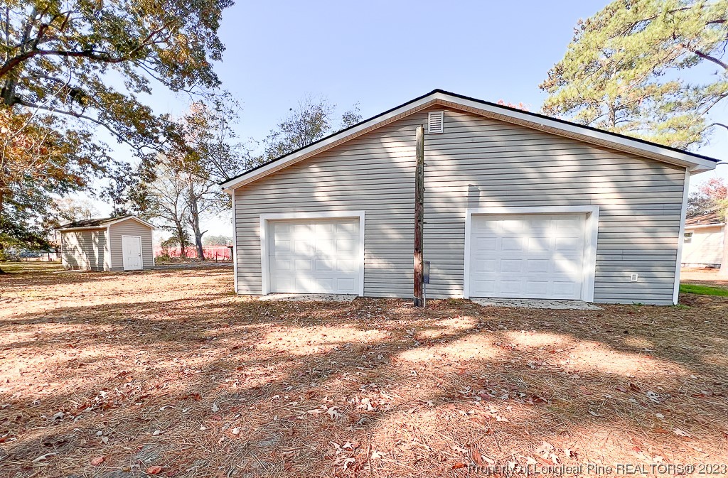 6114 Sandy Creek Road Stedman, NC 28391 - Photo 29 of 34 a view of a house with a yard