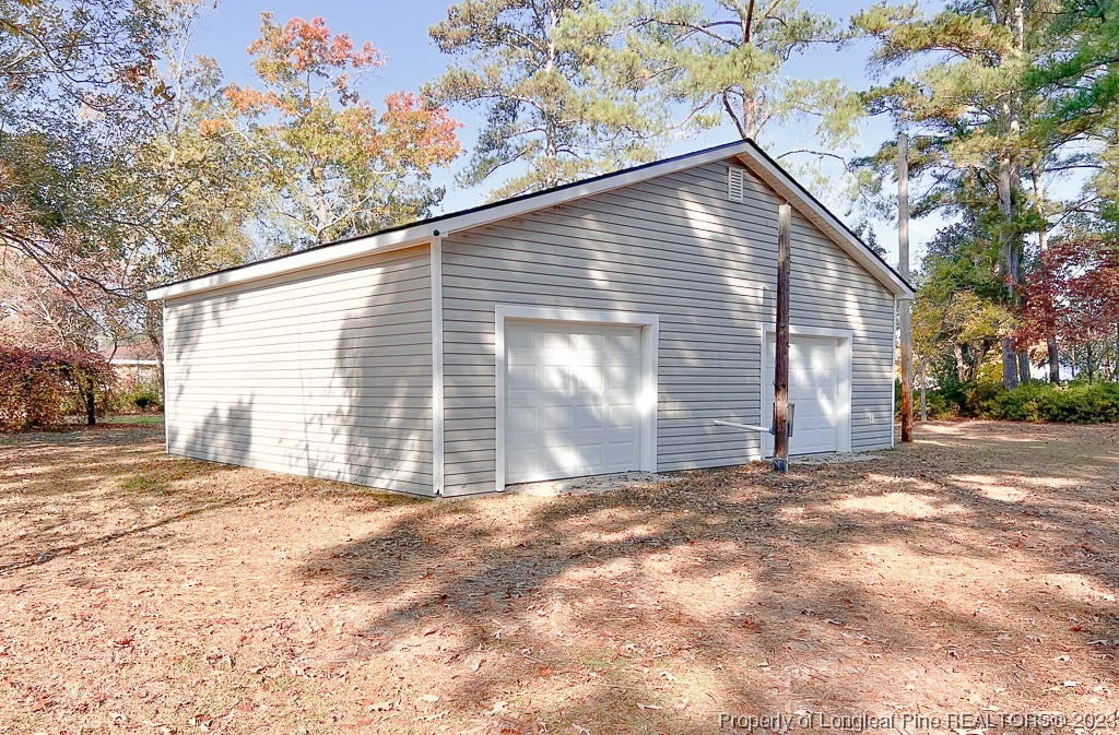 6114 Sandy Creek Road Stedman, NC 28391 - Photo 30 of 34 a view of a house with a yard and garage