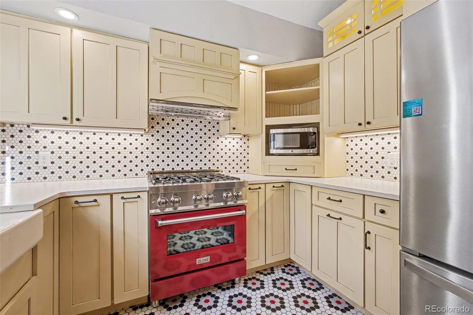 23666 Genesee Village Road Golden, CO 80401 - Photo 11 of 49 a kitchen with stainless steel appliances a stove and a refrigerator