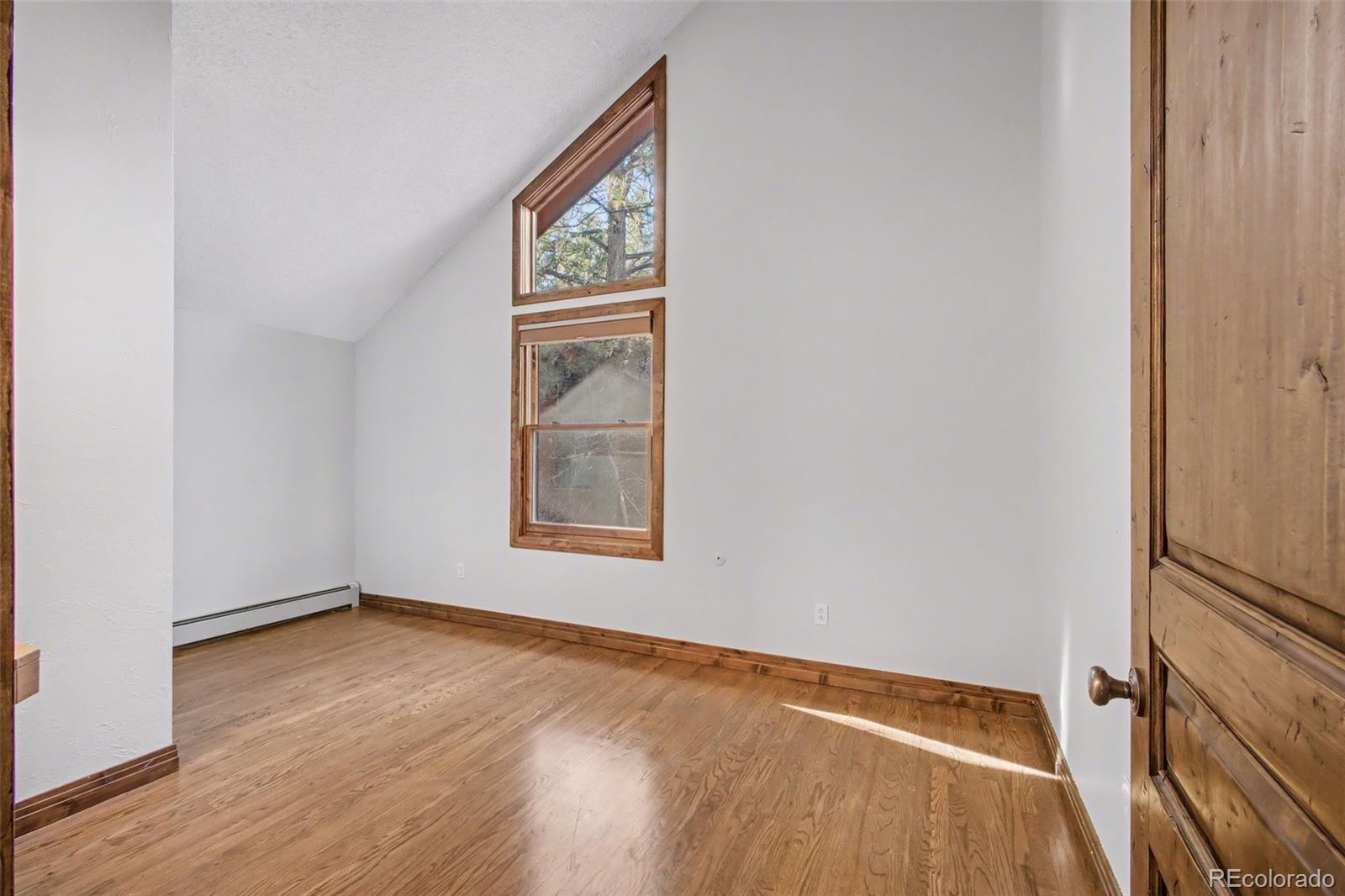 23666 Genesee Village Road Golden, CO 80401 - Photo 19 of 49 an empty room with windows