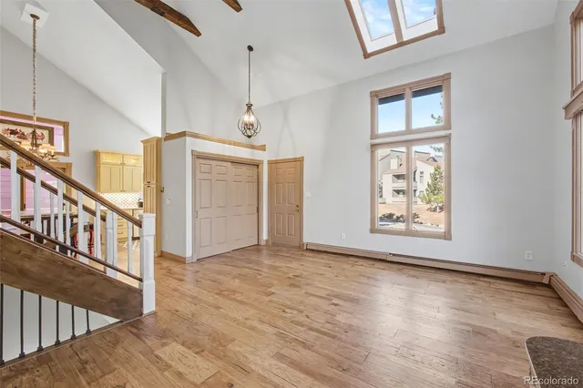 a view of an empty room with wooden floor
