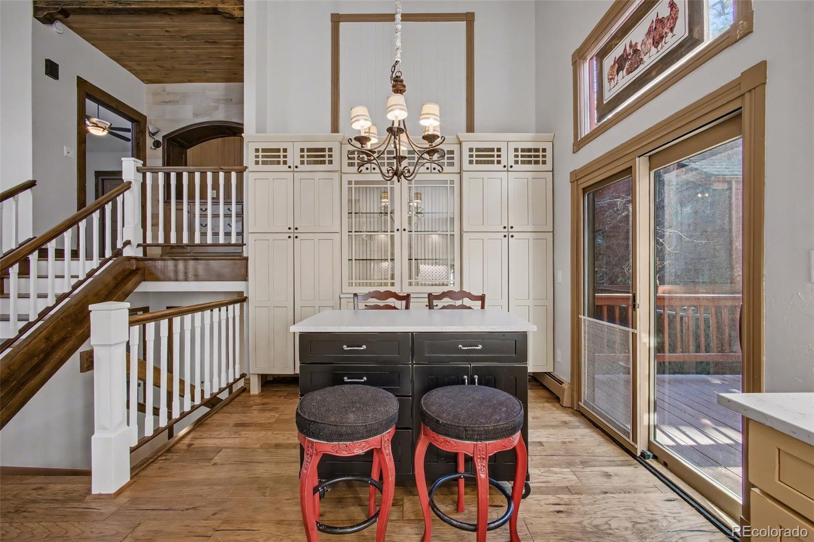 23666 Genesee Village Road Golden, CO 80401 - Photo 9 of 49 a view of a dining room with wooden floor and chandelier