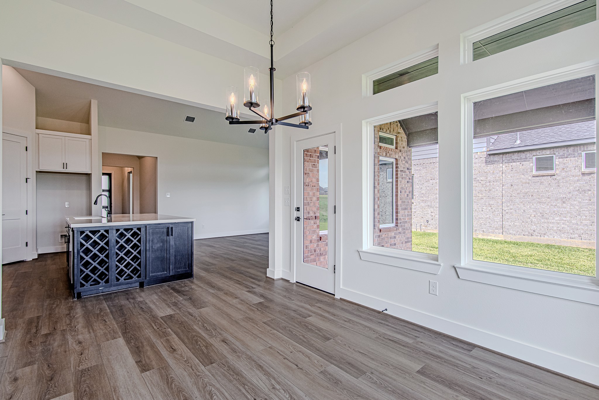 157 Peninsula Point Drive Montgomery, TX 77356 - Photo 11 of 33 a view of workspace with wooden floor windows and a chandelier