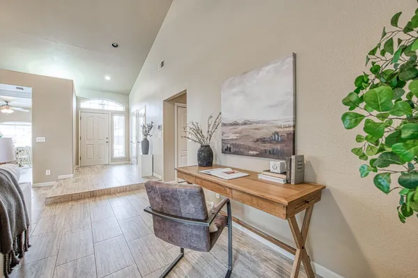 a living room with furniture and a potted plant
