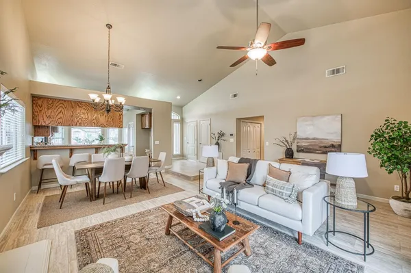a living room with furniture and a chandelier