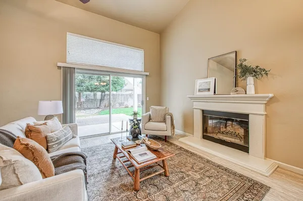 a living room with furniture and a fireplace