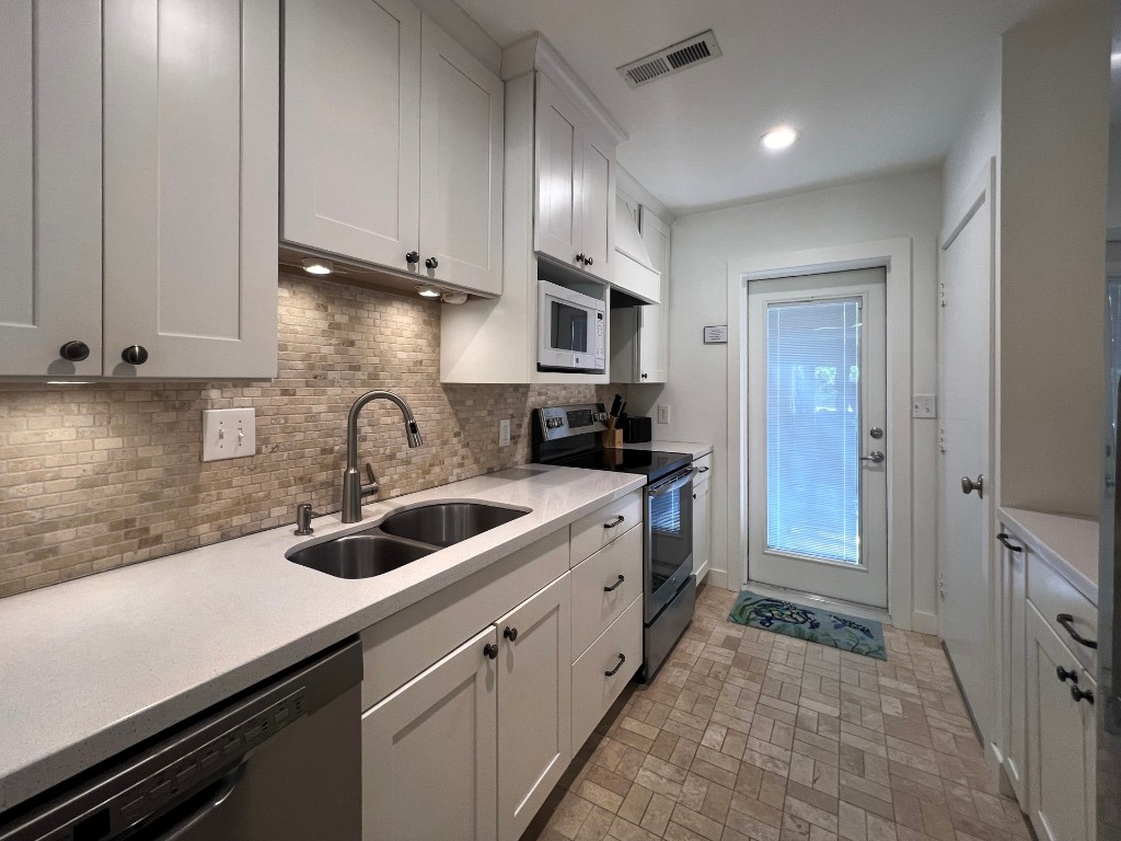 3314 Sea Marsh Road Fernandina Beach, FL 32034 - Photo 12 of 32 a kitchen that has a sink and cabinets