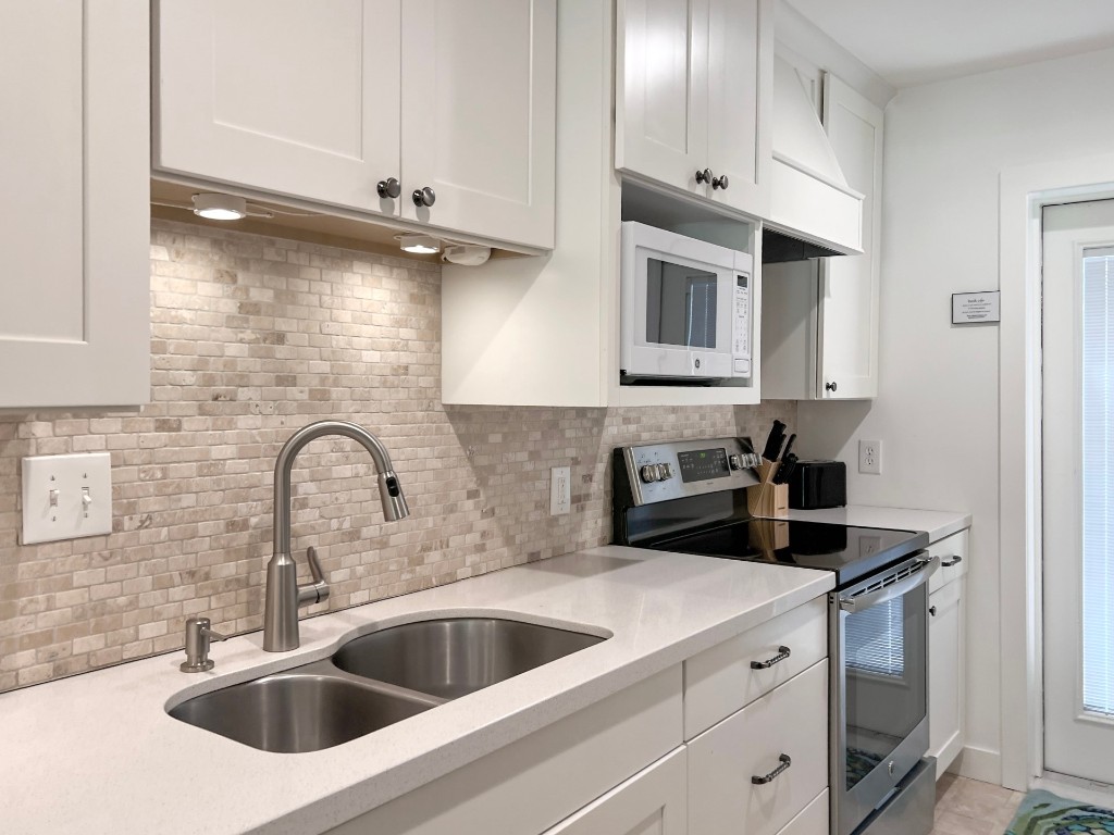 3314 Sea Marsh Road Fernandina Beach, FL 32034 - Photo 13 of 32 a kitchen with stainless steel appliances granite countertop a sink a stove and cabinets