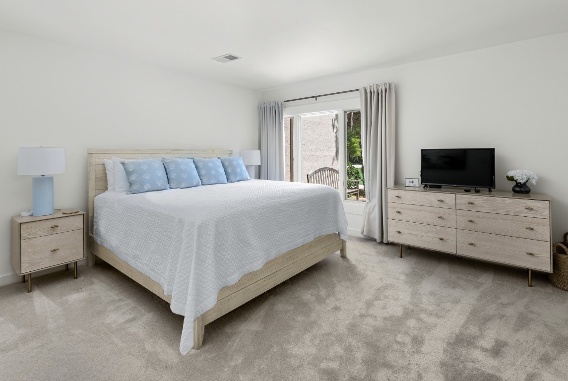 3314 Sea Marsh Road Fernandina Beach, FL 32034 - Photo 15 of 32 a spacious bedroom with a bed and tv