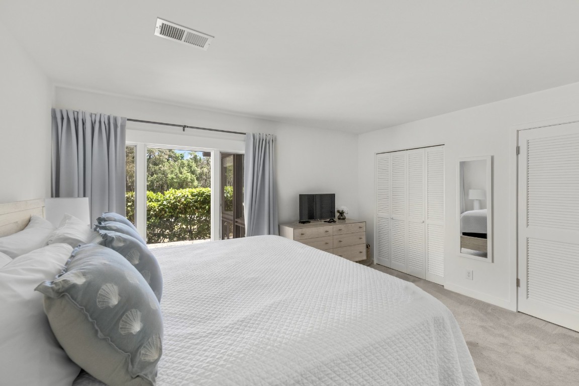 3314 Sea Marsh Road Fernandina Beach, FL 32034 - Photo 16 of 32 a bedroom with a bed and a large window