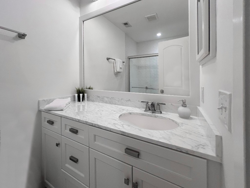 3314 Sea Marsh Road Fernandina Beach, FL 32034 - Photo 17 of 32 a bathroom with a granite countertop sink and a mirror