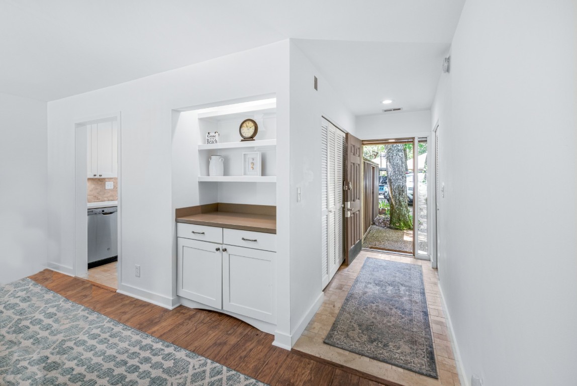 3314 Sea Marsh Road Fernandina Beach, FL 32034 - Photo 4 of 32 a kitchen with a refrigerator and white cabinets