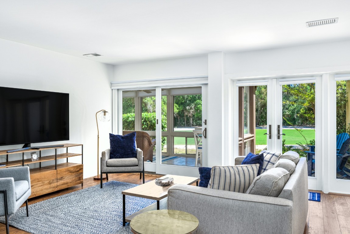 3314 Sea Marsh Road Fernandina Beach, FL 32034 - Photo 8 of 32 a living room with furniture and a flat screen tv