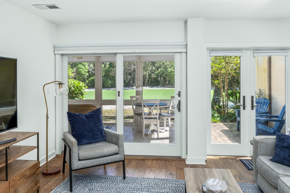 3314 Sea Marsh Road Fernandina Beach, FL 32034 - Photo 9 of 32 a living room with furniture and a floor to ceiling window
