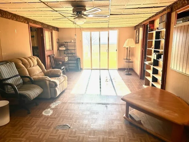 a living room with furniture and a dining table