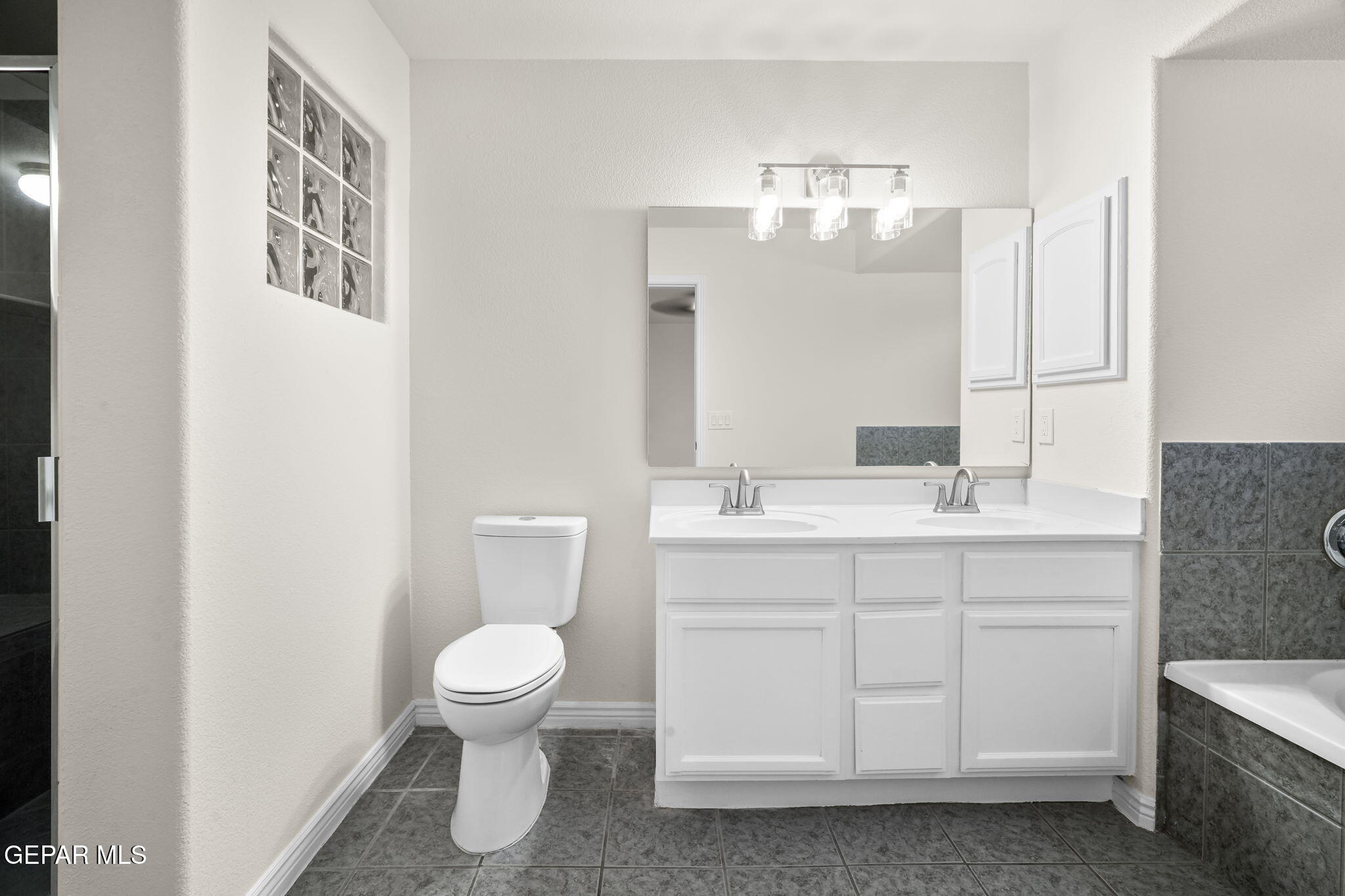 3657 Sammy Reece PIace El Paso, TX 79938 - Photo 26 of 56 a bathroom with a toilet sink and mirror