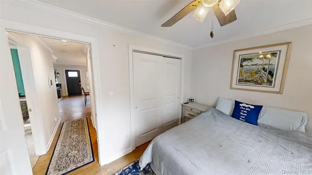 a bedroom with bed and a chandelier