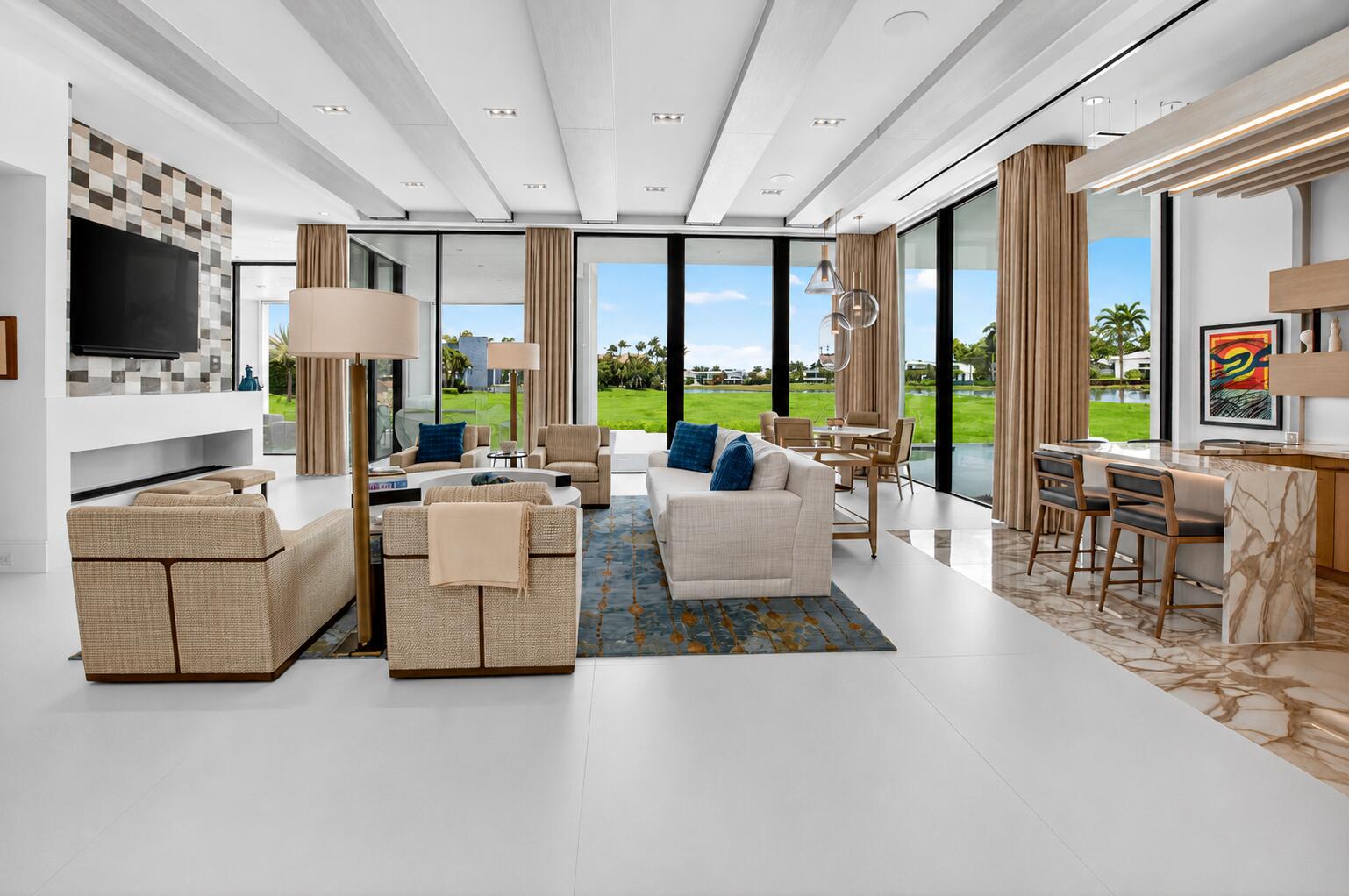 6960 Lake Estates Court Boca Raton, FL 33496 - Photo 5 of 58 a living room with furniture a flat screen tv and a floor to ceiling window