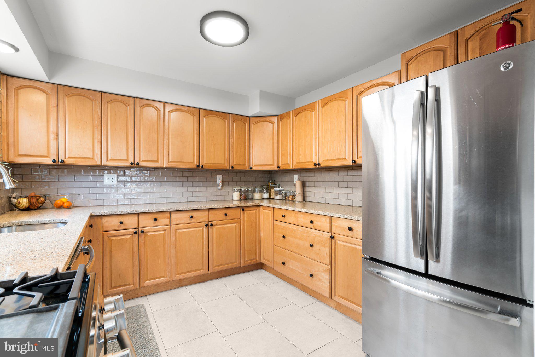 609 Perth Place Silver Spring, MD 20901 - Photo 13 of 46 a kitchen with stainless steel appliances granite countertop a refrigerator sink and cabinets