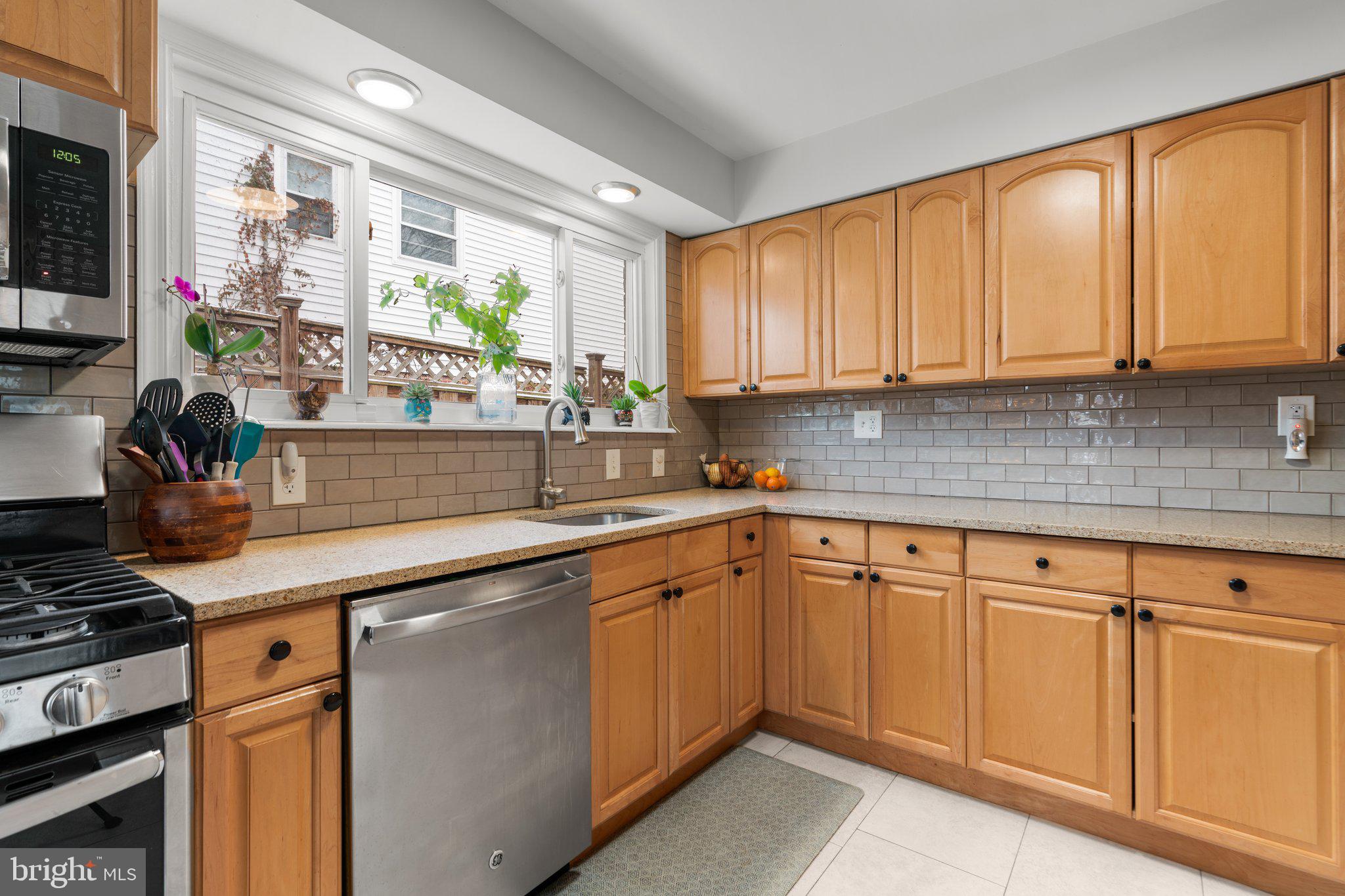 609 Perth Place Silver Spring, MD 20901 - Photo 15 of 46 a kitchen with stainless steel appliances granite countertop a sink and cabinets