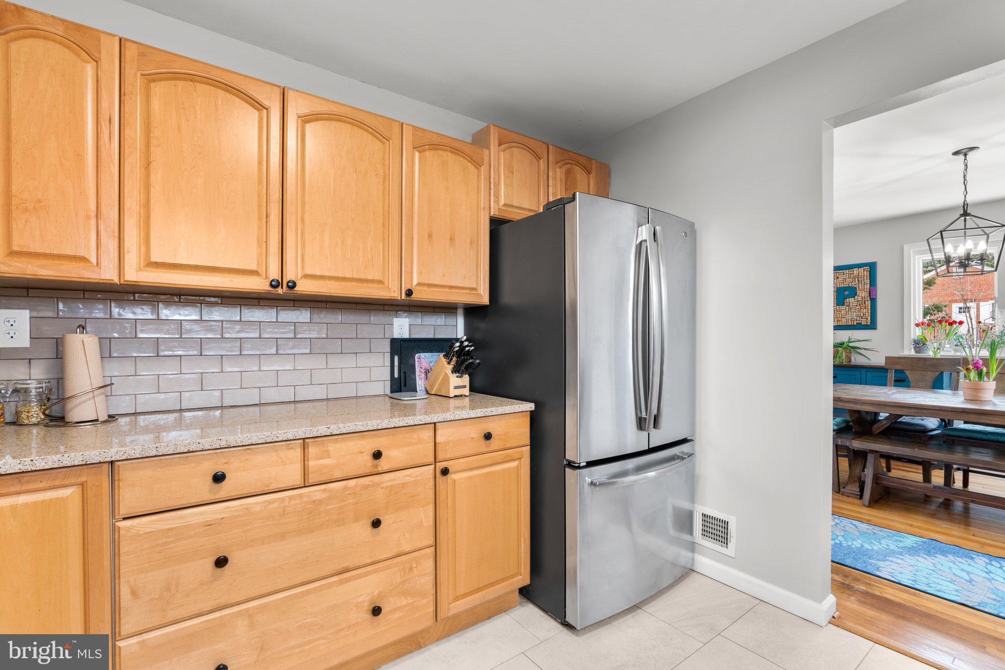 609 Perth Place Silver Spring, MD 20901 - Photo 17 of 46 a kitchen with stainless steel appliances granite countertop a refrigerator and cabinets