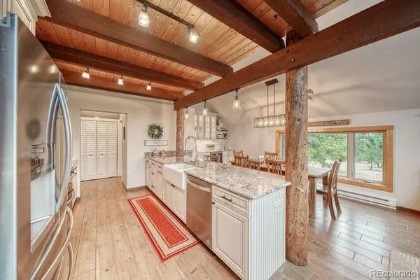 a large white kitchen with a large window