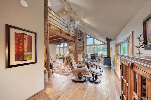 a view of a dining room with furniture large windows and wooden floor