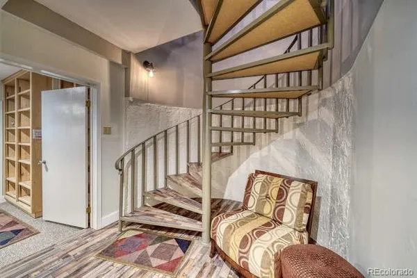 a bedroom with a bed and large windows