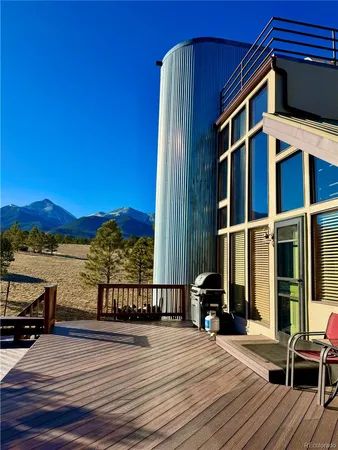 a view of a balcony with chairs and wooden floor