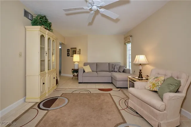 a living room with furniture a rug and a chandelier