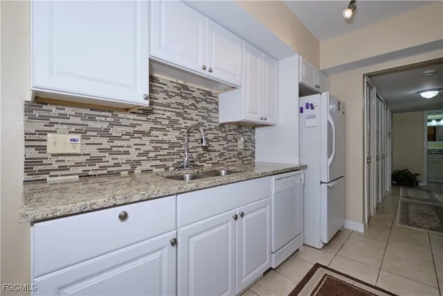 a kitchen with stainless steel appliances granite countertop a sink and cabinets