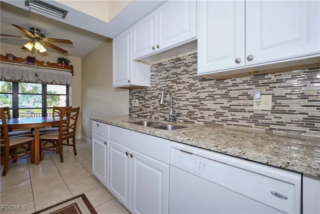 a kitchen with sink cabinets and window