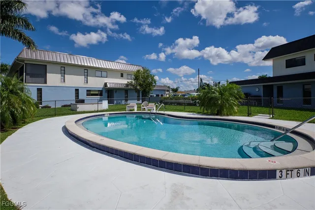 a view of a house with swimming pool and a yard