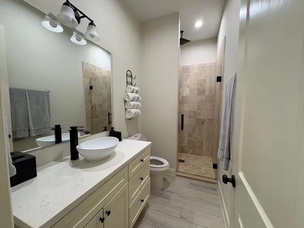 a bathroom with a double vanity sink mirror double and shower