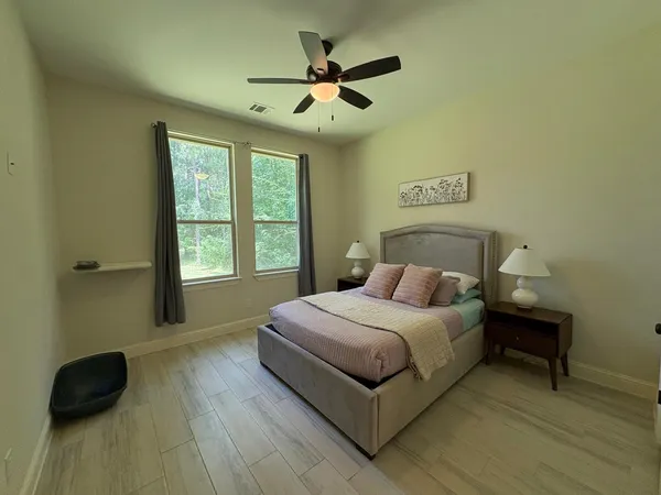 a bedroom with a bed and a window