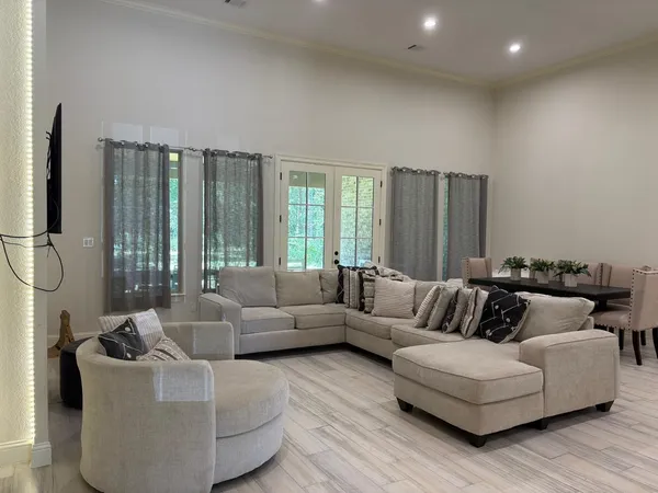 a living room with furniture and a large window