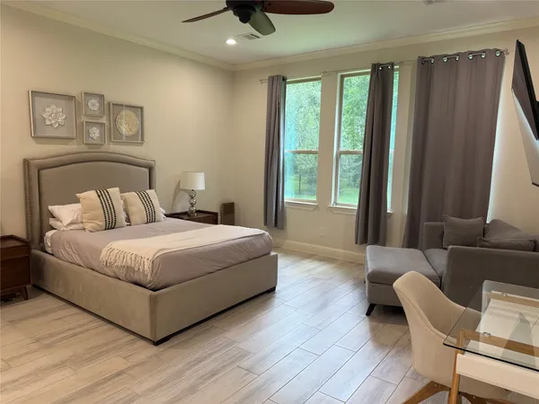 a bedroom with a bed and glass window