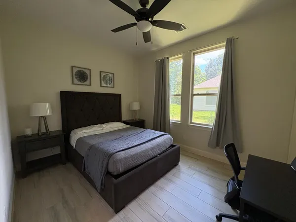 a bedroom with a bed and a window