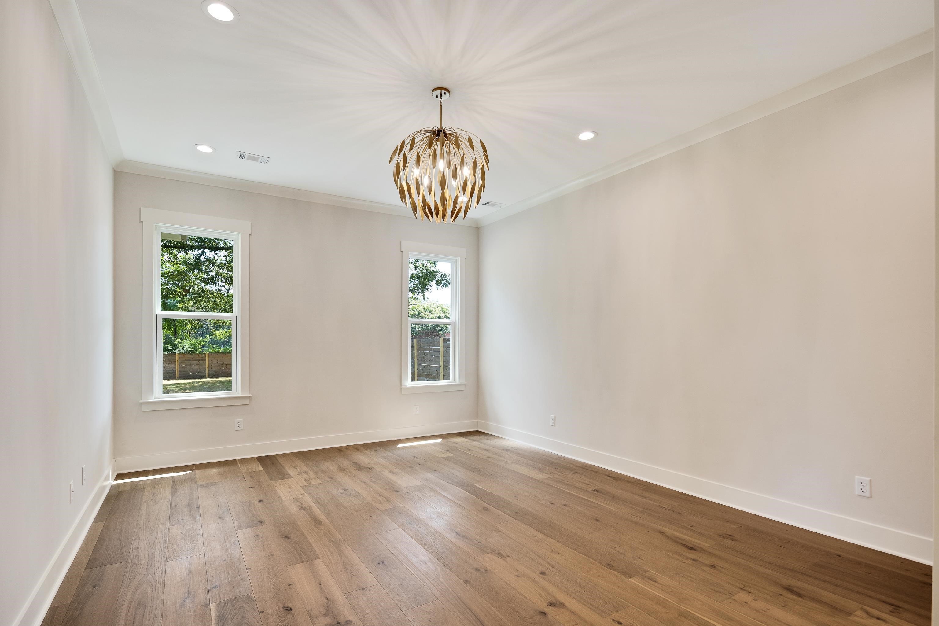 352 Avon Road Memphis, TN 38117 - Photo 12 of 26 Spare room with hardwood / wood-style flooring, a chandelier, recessed lighting, and ornamental molding
