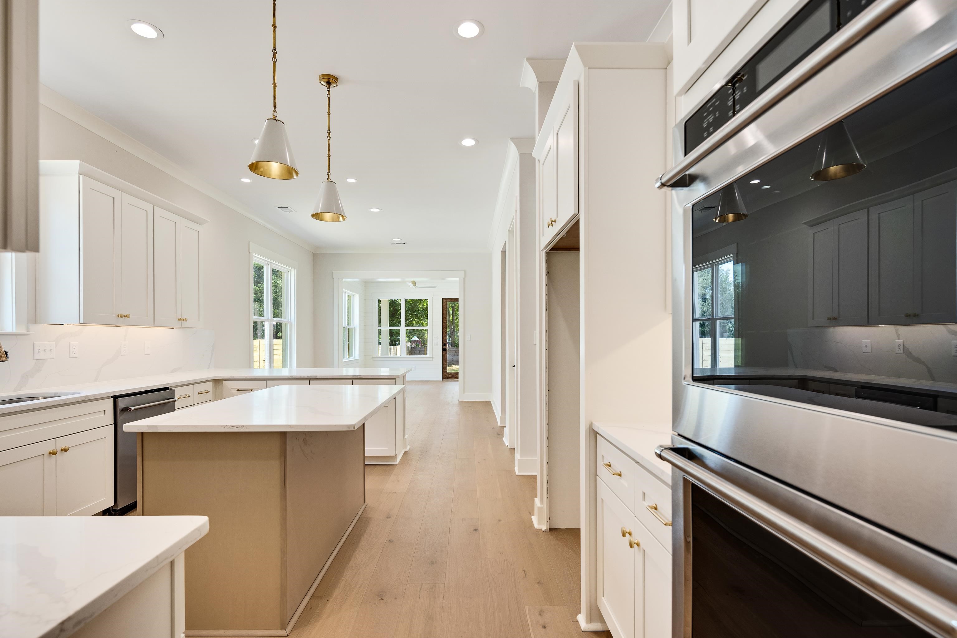 352 Avon Road Memphis, TN 38117 - Photo 10 of 26 Kitchen with appliances with stainless steel finishes, backsplash, ornamental molding, light wood-style flooring, and a kitchen island