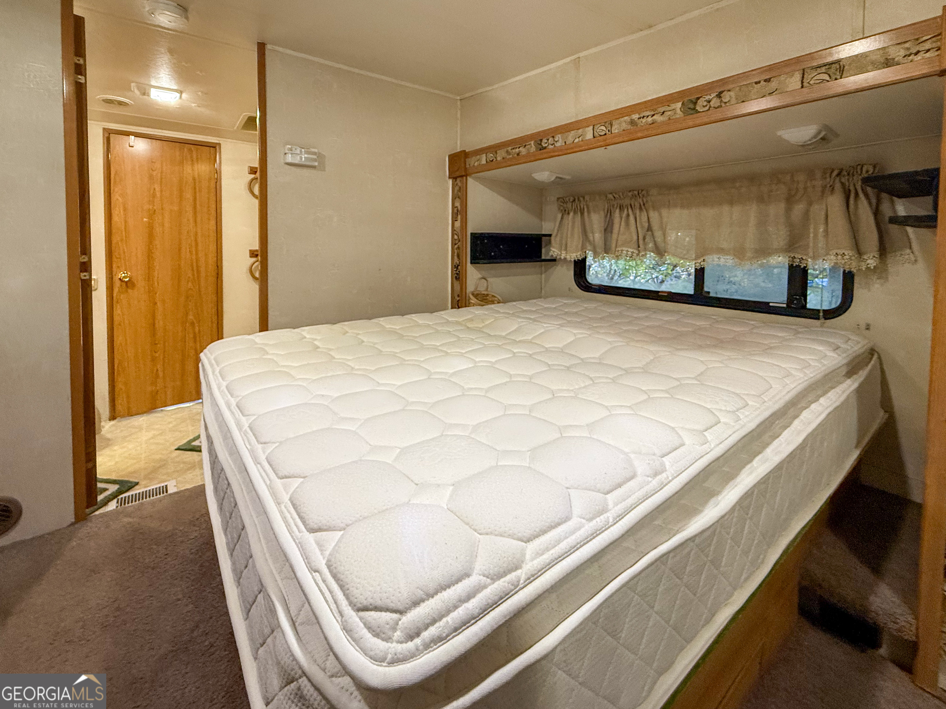 159 Canyon Pass Cleveland, GA 30528 - Photo 14 of 19 a bedroom with a bed and a mirror