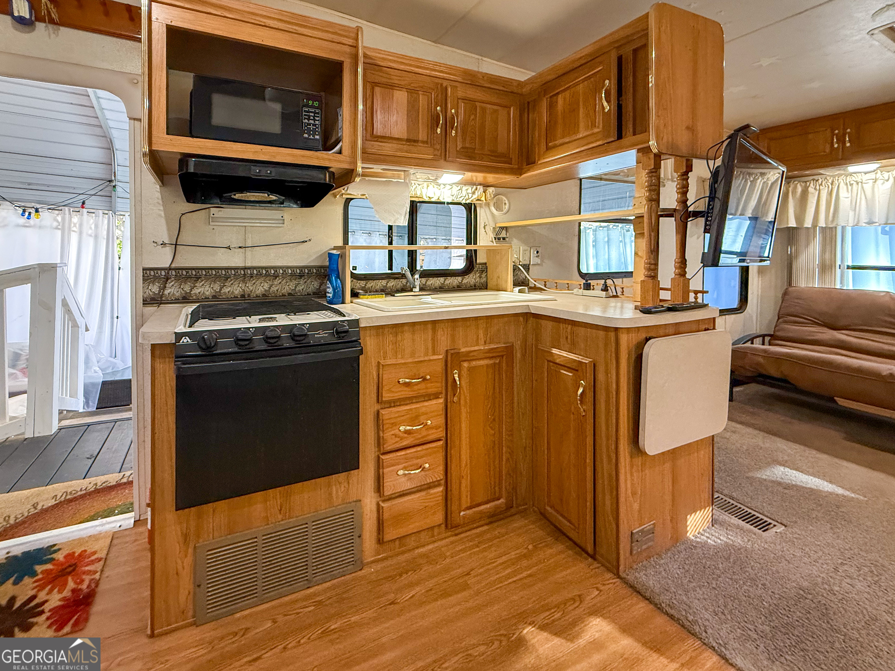 159 Canyon Pass Cleveland, GA 30528 - Photo 5 of 19 a kitchen with stainless steel appliances granite countertop a stove a sink and a microwave