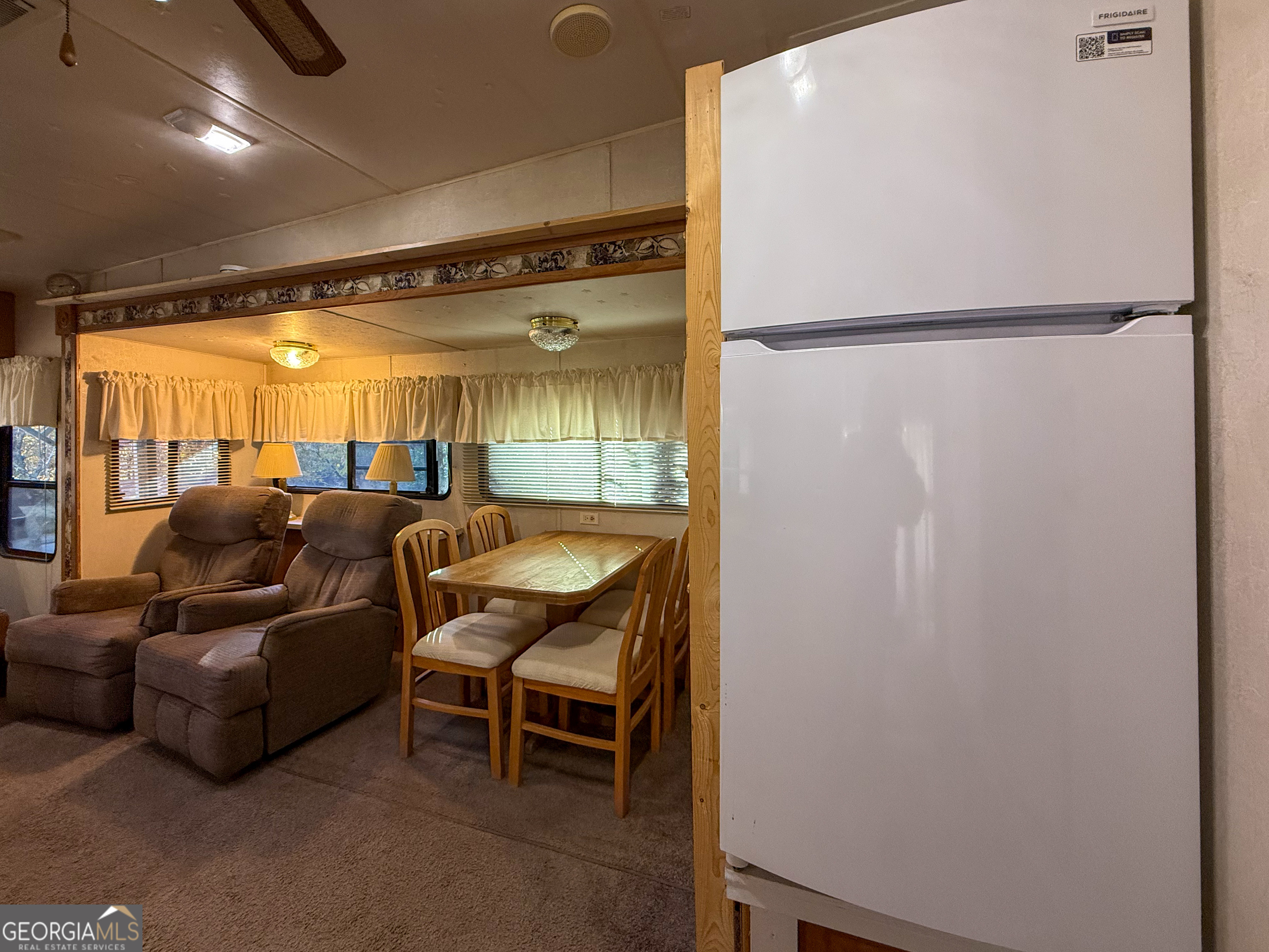 159 Canyon Pass Cleveland, GA 30528 - Photo 6 of 19 a living room with a couch and a refrigerator