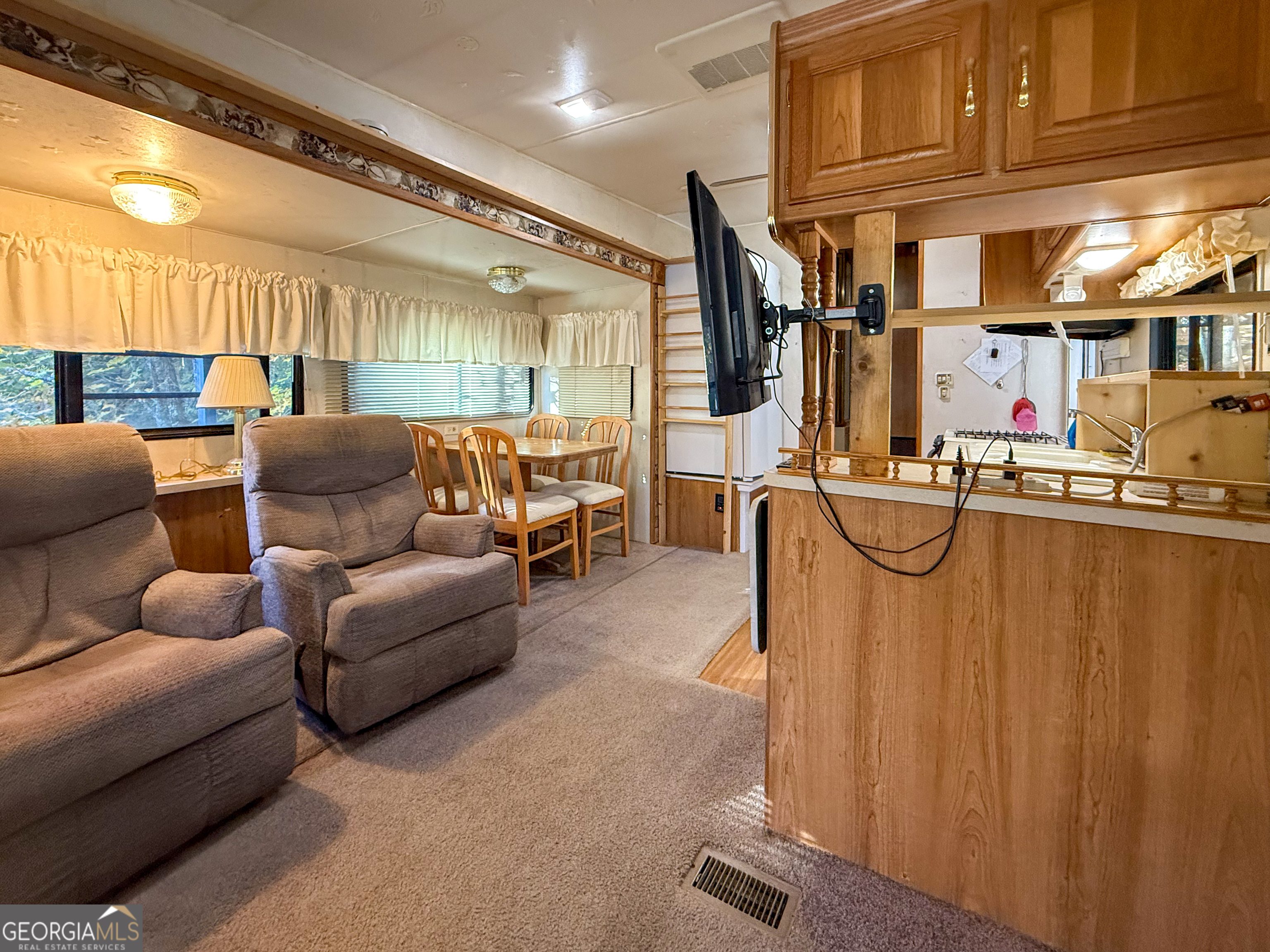 159 Canyon Pass Cleveland, GA 30528 - Photo 8 of 19 a living room with furniture a ceiling fan and a window