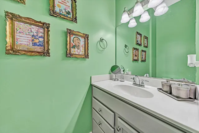 a close view of walk in closet with clothes and shoes