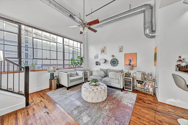 a kitchen with a refrigerator a stove top oven a sink and a potted plant