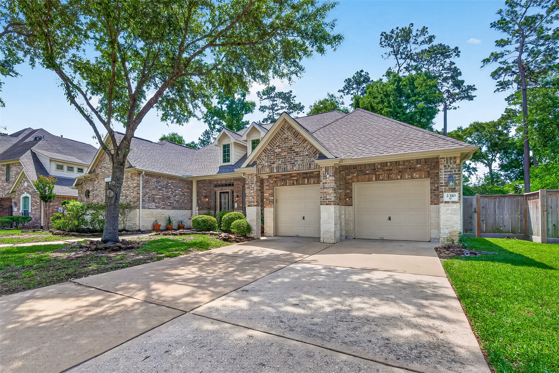 2310 Spring Lake Park Lane Spring, TX 77386 - Photo 1 of 47 a front view of a house with a garden and trees