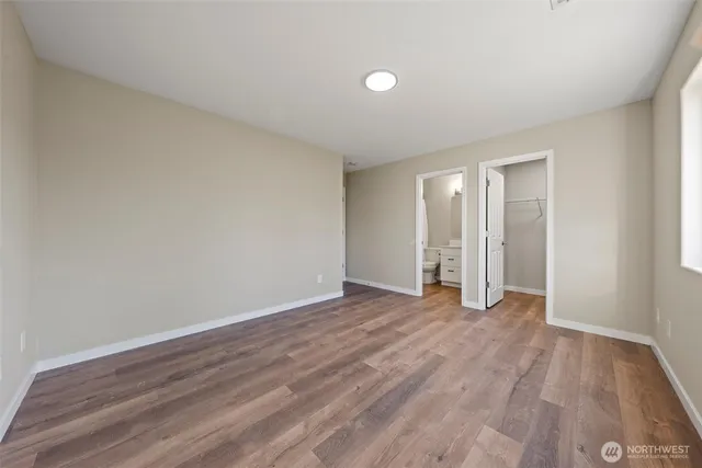 a view of backyard of house and car parked