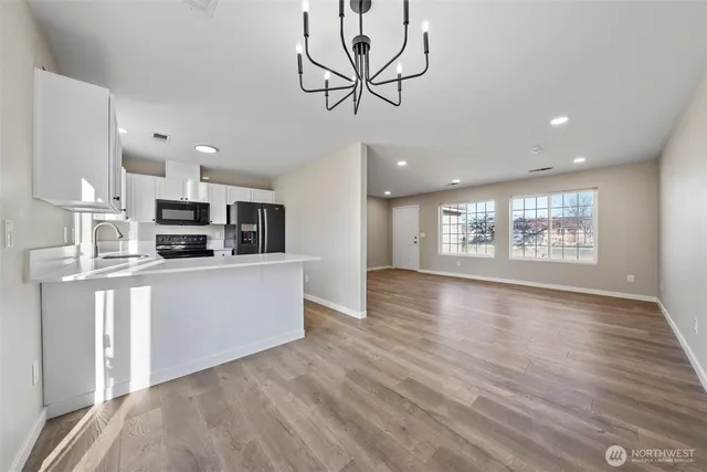 a kitchen with stainless steel appliances a refrigerator stove microwave and sink